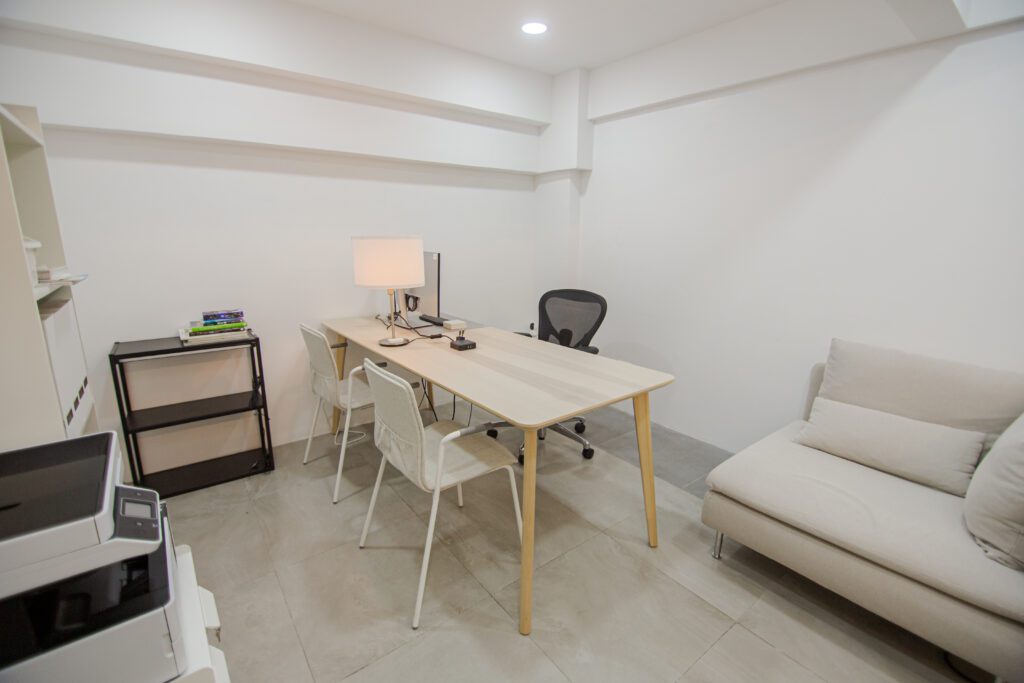 Private office space at From Here Cebu featuring a clean white interior, desk setup, and seating for focused work.